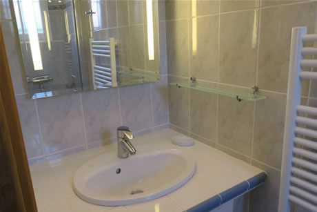 Un miroir est plac&eacute; en face du lavabo.